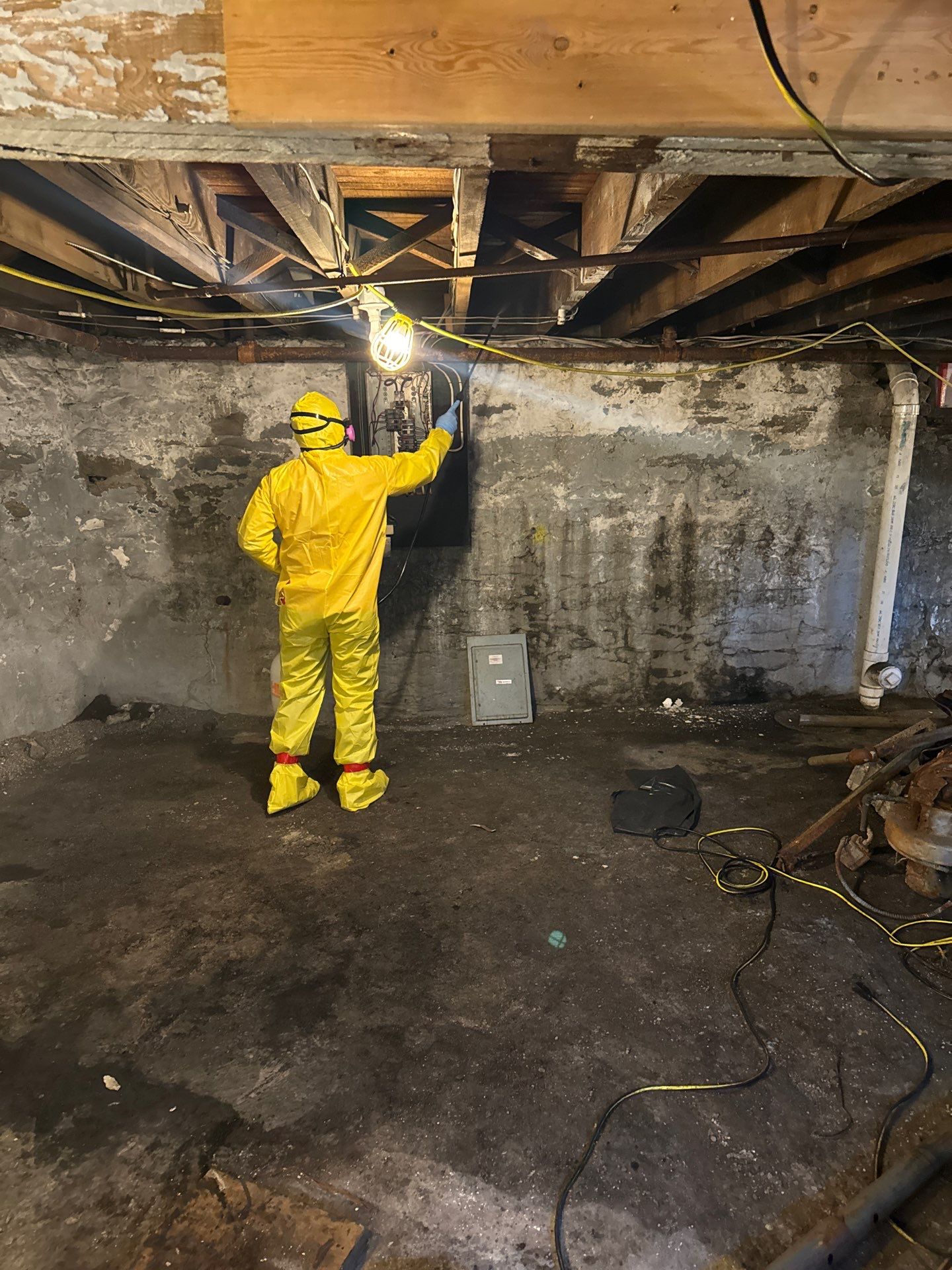 ertified technician in full hazmat suit inspecting damaged electrical panel during mold abatement and water damage restoration in Dunham PA 17111